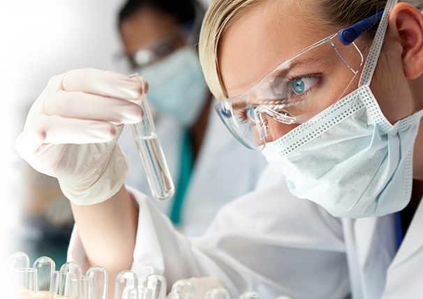Image of a scientist inspecting a glass vial